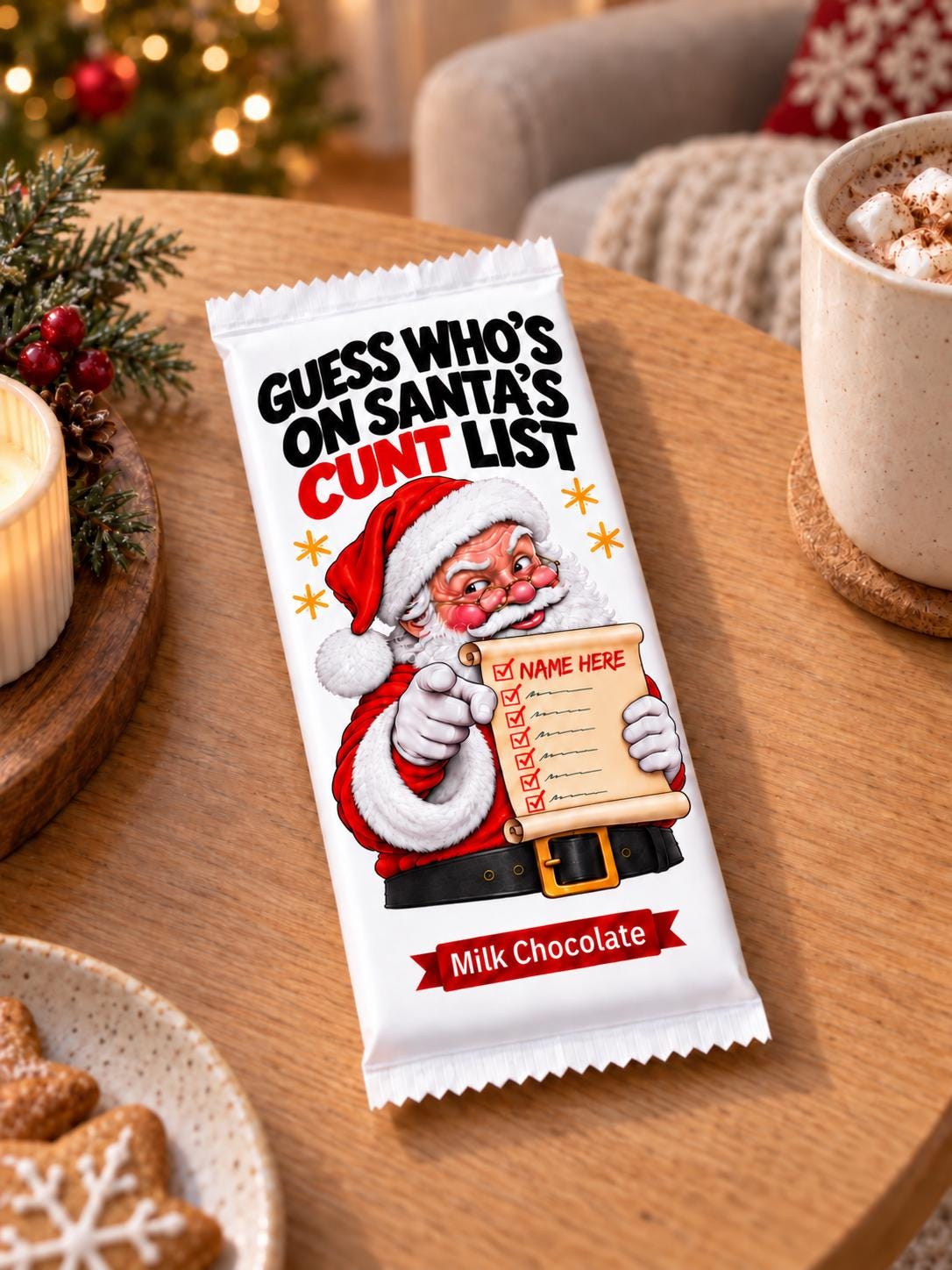 A milk chocolate bar in a beige wrapper   including chocolate bar, featuring a festive illustration of Santa Claus pointing to a list with the text 'GUESS WHO'S ON SANTA'S NAUGHTY  LIST'. The bar is placed on a wooden table in a cozy holiday setting with a mug, cookies, and a blurred Christmas tree in the background.